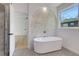 Luxury bathroom with soaking tub, window, and modern fixtures for a spa-like experience at 644 Glendale Rd, Scottdale, GA 30079