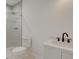 A well-lit bathroom features a sleek vanity, modern fixtures, and a glass-enclosed shower at 644 Glendale Rd, Scottdale, GA 30079