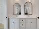 Modern bathroom with a double sink vanity and two arched mirrors at 644 Glendale Rd, Scottdale, GA 30079