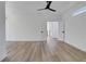 Large bedroom with hardwood floors, fan, and a view leading into another room at 644 Glendale Rd, Scottdale, GA 30079