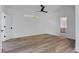 Bright bedroom features hardwood floors, fan, and a view leading to the bathroom at 644 Glendale Rd, Scottdale, GA 30079