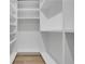 Walk-in closet with white shelves and hardwood flooring offers ample storage space at 644 Glendale Rd, Scottdale, GA 30079