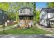 Inviting two-story home with a cozy front porch and a lush green lawn at 644 Glendale Rd, Scottdale, GA 30079