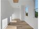 Bright hallway with wood floors, a window and shiplap walls at 644 Glendale Rd, Scottdale, GA 30079