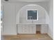 A well lit serving area with white cabinets and quartz countertops sits beneath an archway and window at 644 Glendale Rd, Scottdale, GA 30079