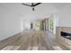 Bright, open-concept living area features modern fireplace, ceiling fan, and seamless flow to kitchen at 644 Glendale Rd, Scottdale, GA 30079