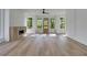 Sun-drenched living room with modern fireplace and hardwood floors leading to an elegant front door at 644 Glendale Rd, Scottdale, GA 30079