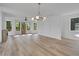 Bright and airy living room with hardwood floors, modern lighting, and multiple windows with natural light at 644 Glendale Rd, Scottdale, GA 30079