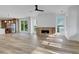 Living room featuring fireplace, hardwood floors, and ample natural light from large windows at 644 Glendale Rd, Scottdale, GA 30079