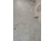 Close-up of shower with gray tile, built-in niche and modern fixtures at 644 Glendale Rd, Scottdale, GA 30079
