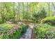 Beautifully landscaped backyard with stone path and colorful bushes at 860 Cramac Dr, Lawrenceville, GA 30046
