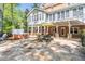 Back patio with hot tub, stone pavers, and outdoor dining set at 860 Cramac Dr, Lawrenceville, GA 30046