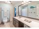 This bathroom features light blue walls and tile, a whale motif, and a long vanity at 860 Cramac Dr, Lawrenceville, GA 30046
