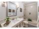 This bathroom features a herringbone tile design on the walls and a modern vanity with a large mirror at 860 Cramac Dr, Lawrenceville, GA 30046