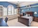 This blue bedroom has an arched window with a window seat and built-in bookcase at 860 Cramac Dr, Lawrenceville, GA 30046