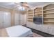 This bedroom has neutral paint and carpet and a large, built-in bookcase with cabinets at 860 Cramac Dr, Lawrenceville, GA 30046