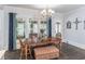Bright dining room with hardwood floors, chandelier, and a large window view at 860 Cramac Dr, Lawrenceville, GA 30046