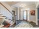 Welcoming foyer features hardwood floors, decorative rug, staircase and front door with leaded glass at 860 Cramac Dr, Lawrenceville, GA 30046