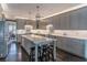 Open concept kitchen featuring gray cabinets, an island with seating, and pendant lighting at 860 Cramac Dr, Lawrenceville, GA 30046