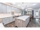 Bright and modern kitchen featuring an island with white countertops and stainless steel appliances at 860 Cramac Dr, Lawrenceville, GA 30046