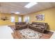 Cozy living room featuring hardwood floors, two leather couches, and a textured ceiling at 860 Cramac Dr, Lawrenceville, GA 30046