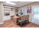 Home office with built-in shelving, a desk, and a view to the outside at 860 Cramac Dr, Lawrenceville, GA 30046