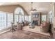Cozy sunroom with stone fireplace, tile flooring, and ample seating at 860 Cramac Dr, Lawrenceville, GA 30046