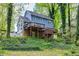 View of a two-story house with a deck overlooking a green yard at 1972 Tanglewood Dr, Snellville, GA 30078