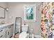 Cozy bathroom with vanity, patterned shower curtain, and ample light at 1972 Tanglewood Dr, Snellville, GA 30078