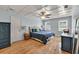 Well-lit bedroom with coffered ceiling, hardwood floors, and blue accents at 1972 Tanglewood Dr, Snellville, GA 30078