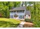 Exterior of beautiful home with black shutters, set on a lush green lot in a neighborhood setting at 1972 Tanglewood Dr, Snellville, GA 30078