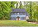 Charming two-story home with a blue exterior, black shutters, and a well-maintained front lawn at 1972 Tanglewood Dr, Snellville, GA 30078
