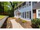 Charming home exterior with blue siding, black shutters, and beautiful landscaping along the walkway at 1972 Tanglewood Dr, Snellville, GA 30078