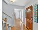 Inviting foyer with hardwood floors, a staircase, and a view into the living room at 1972 Tanglewood Dr, Snellville, GA 30078