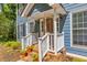 Close-up of the lovely front porch with decorative door and brick trim at 1972 Tanglewood Dr, Snellville, GA 30078