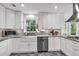 Bright kitchen with granite countertops, stainless steel appliances, custom cabinets, and gray tile floor at 1972 Tanglewood Dr, Snellville, GA 30078