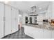 Bright kitchen features white cabinets and an island with granite countertops at 1972 Tanglewood Dr, Snellville, GA 30078