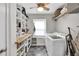 Well-organized laundry room with shelving, washer, and dryer at 1972 Tanglewood Dr, Snellville, GA 30078