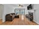 Inviting living room featuring hardwood floors, fireplace, ceiling fan, and a comfortable sectional sofa at 1972 Tanglewood Dr, Snellville, GA 30078