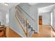 Bright staircase with wood railing, leading to the upper level of the home at 1972 Tanglewood Dr, Snellville, GA 30078