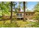 The backyard of this home has a patio, mature trees, and is nicely landscaped with blooming bushes at 2343 Kings Point Dr, Dunwoody, GA 30338