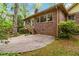 Backyard showcasing a brick facade, cozy patio, and lush greenery, ideal for outdoor living at 2343 Kings Point Dr, Dunwoody, GA 30338
