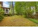 Lush backyard featuring mature trees, natural landscaping, and a serene setting at 2343 Kings Point Dr, Dunwoody, GA 30338