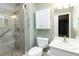 Bathroom featuring tiled glass shower, sink, cabinet for storage, mirror, and tile flooring at 2343 Kings Point Dr, Dunwoody, GA 30338