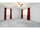Bright bedroom with carpet, fan, and large windows with curtains and blinds for privacy at 2343 Kings Point Dr, Dunwoody, GA 30338