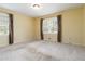 Inviting bedroom features large windows with decorative drapes and neutral carpet at 2343 Kings Point Dr, Dunwoody, GA 30338