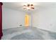 Bedroom featuring light blue carpet, white walls, fan, vent, and windows with natural light at 2343 Kings Point Dr, Dunwoody, GA 30338