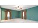 Cozy bedroom with neutral carpet, decorative curtains, and a ceiling fan at 2343 Kings Point Dr, Dunwoody, GA 30338