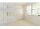 Walk-in closet with shelving, white tile flooring, door, and window with natural light at 2343 Kings Point Dr, Dunwoody, GA 30338