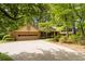 Traditional home with large driveway and mature trees providing ample shade at 2343 Kings Point Dr, Dunwoody, GA 30338